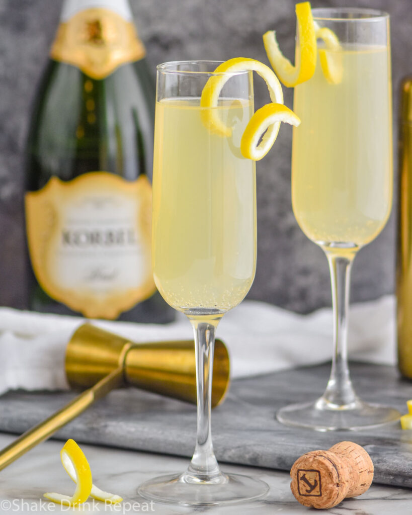 two glasses of french 75 with lemon twist and champagne