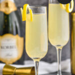 two glasses of french 75 with lemon twist and champagne