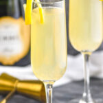 two glasses of french 75 with lemon twist and champagne