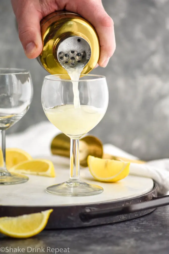 Gin Fizz drink being poured into glass