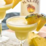 sugared rim glass of malibu pineapple margarita with coconut garnish