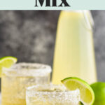 two glasses with salted rims of margaritas made with homemade margarita mix, lemons and limes