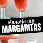 glasses of frozen margaritas with sugared rim and fresh strawberries