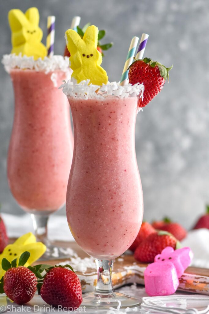 Bunny Colada in a glass with strawberries, coconut and peeps garnishing it with a straw