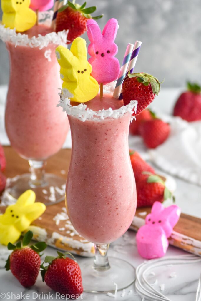 Bunny Colada in a glass with strawberries, coconut and peeps garnishing it with a straw