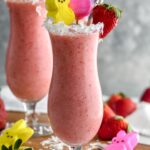 Bunny Colada in a glass with strawberries, coconut and peeps garnishing it with a straw
