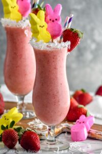 Bunny Colada in a glass with strawberries, coconut and peeps garnishing it with a straw