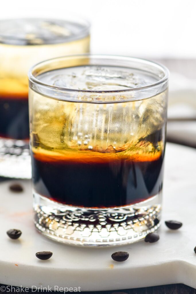 two glasses of mind eraser cocktail with ice and coffee beans