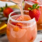 glass of Strawberry Margarita Sangria with sugar coated rim and garnish