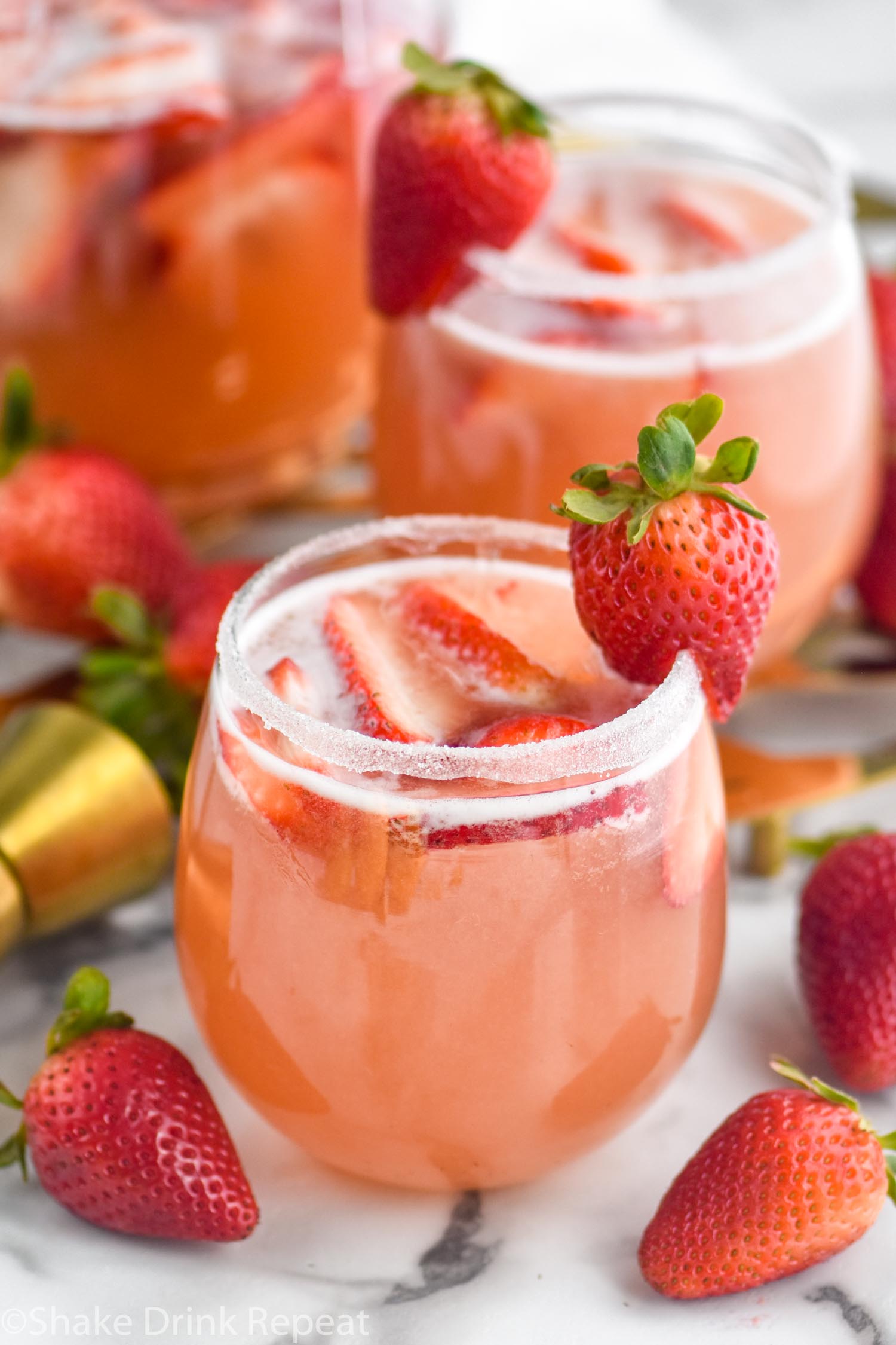 two glasses of strawberry margarita sangria with sugar coated rim