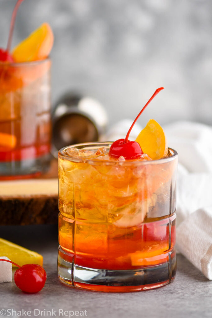 glass of wisconsin old fashioned with ice, orange, and cherry