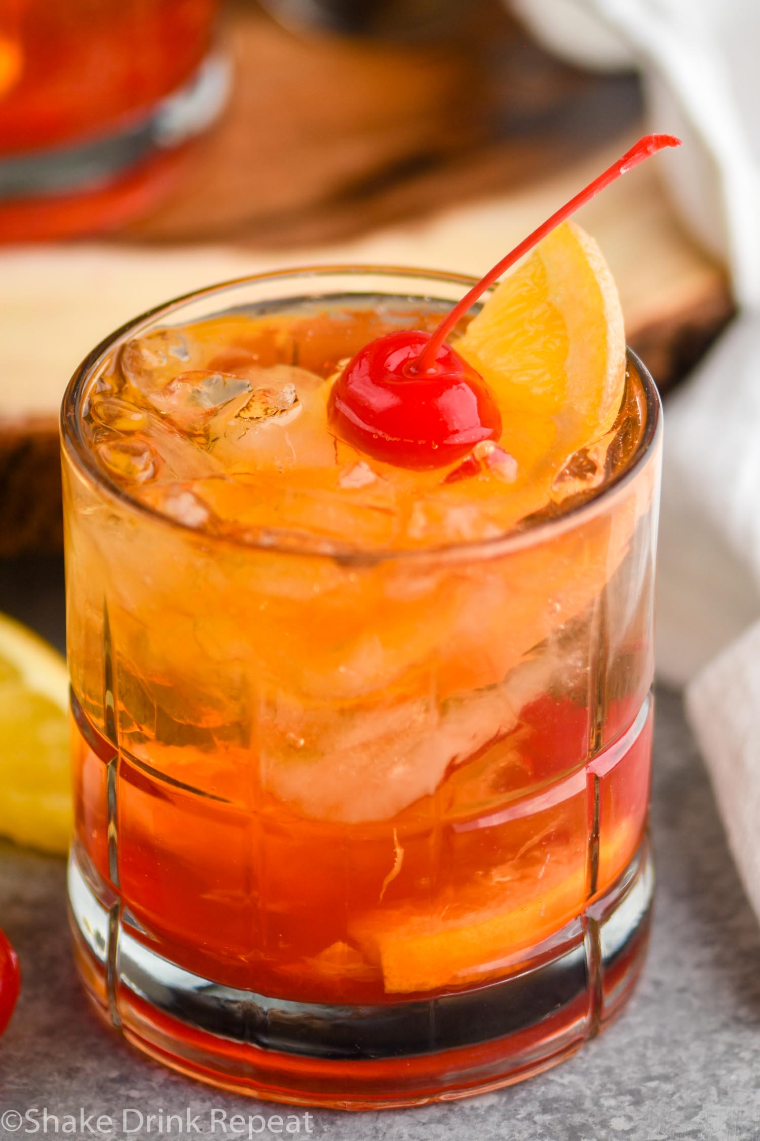 glass of wisconsin brandy old fashioned with ice, brandy, cherry, and orange