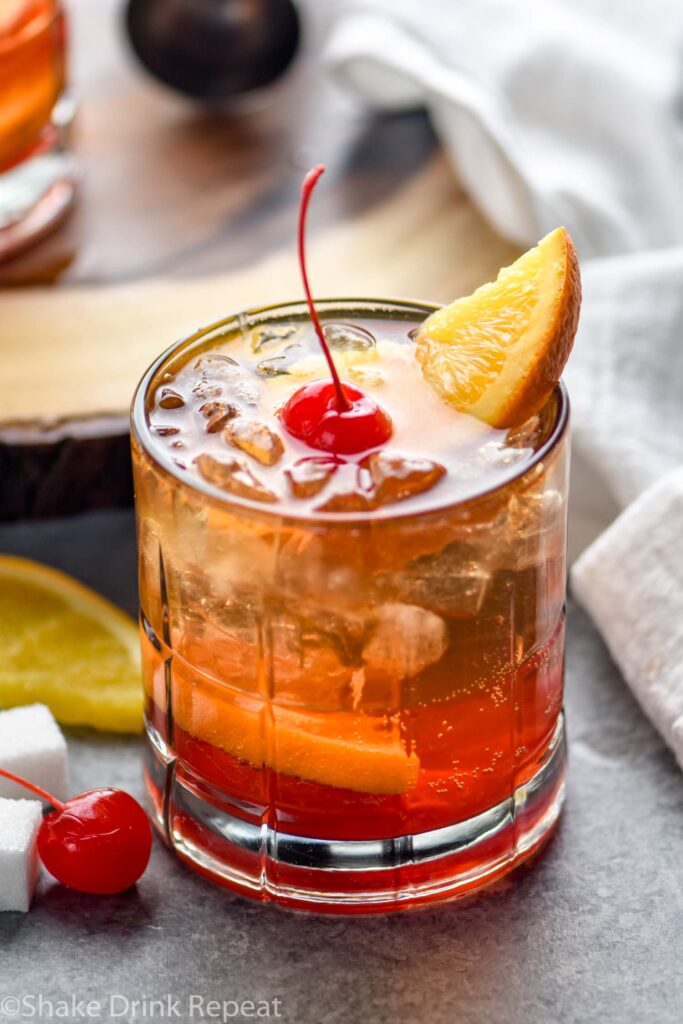 glass of wisconsin old fashioned with ice, cherry, and orange