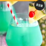 glass of blue hawaii with ice, cherry, pineapple, and a straw