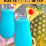 two glasses of frozen blue hawaiian with straw, umbrella, pineapple, and cherry garnish