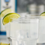 two glasses of gin gimlet with ice and lime