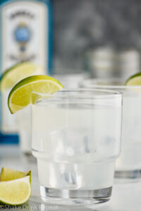 two glasses of gin gimlet with ice and lime