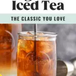 man stirring glass of long island iced tea with ice and lemon wedge