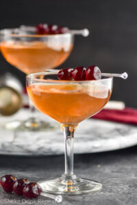 two glasses of Manhattan cocktail with cherry garnish