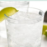 glass of vodka soda with ice and lime