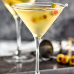 two glasses of dirty martini with green olives