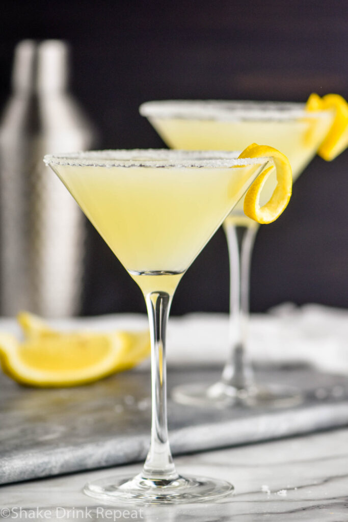 two glasses of lemon drop martini with sugared rim and lemon twist
