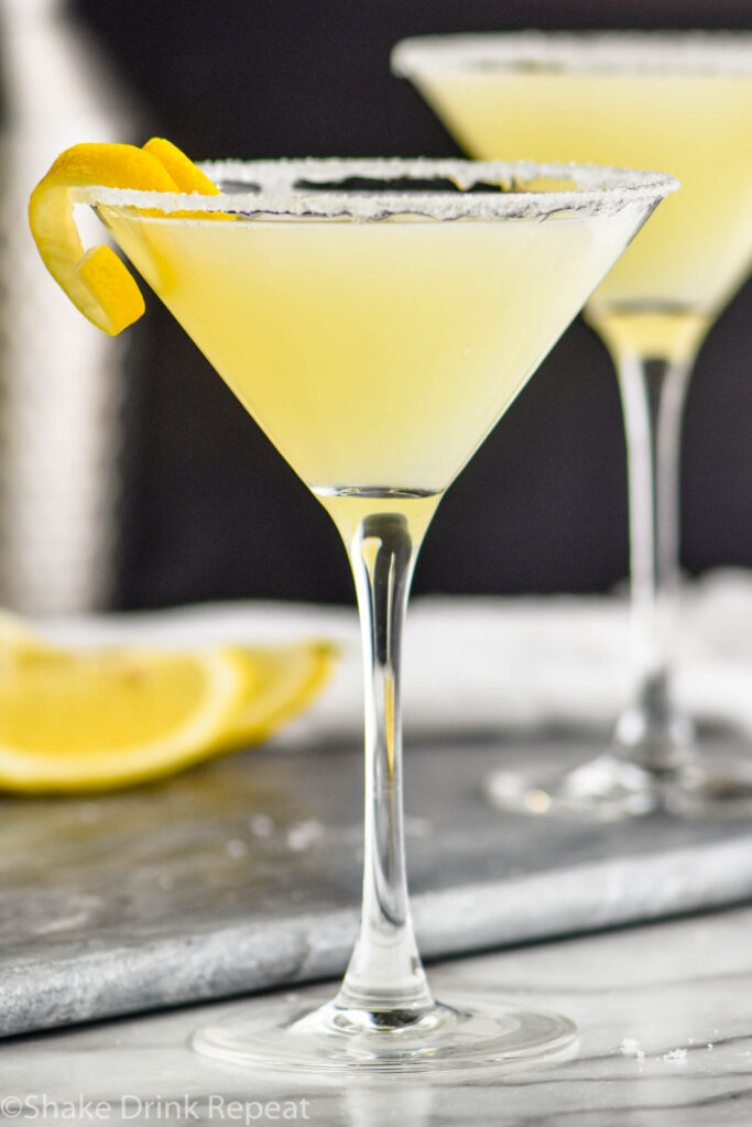 two glasses of lemon drop martini with sugared rim and lemon twist