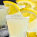 glasses of lemon drop shot with sugared rim and lemon wedge