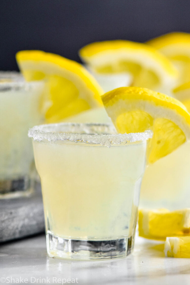 glasses of lemon drop shot with sugared rim and lemon wedge