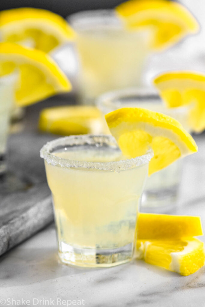 shot glasses of lemon drop shots with sugared rim and lemon wedge