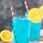 two glasses of walk me down with ice, straws, and lemons