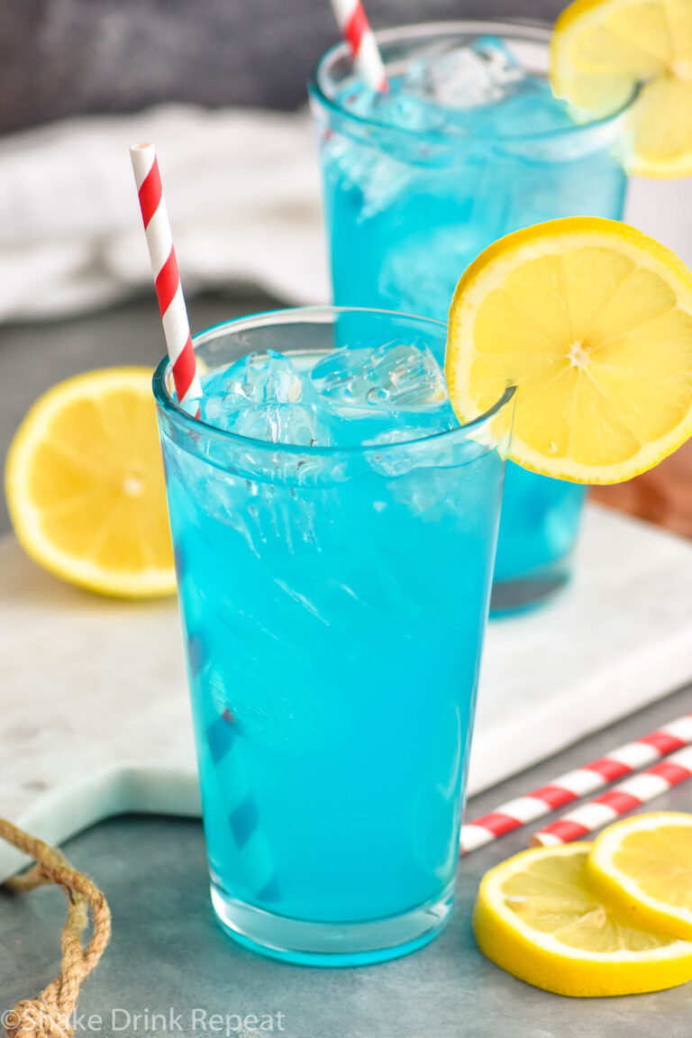 two glasses of walk me down cocktail with ice, straws, and lemons