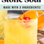 glass of Amaretto Stone Sour with ice and orange slice and cherry garnish