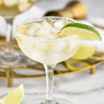 two glasses of Cadillac Margarita with ice, salted rim and lime wedge garnish