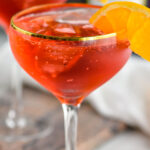 two glasses of Campari Spritz with ice and orange slice garnish
