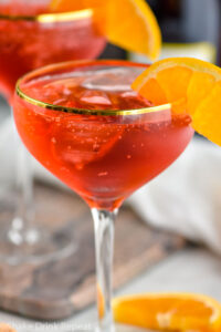 two glasses of Campari Spritz with ice and orange slice garnish