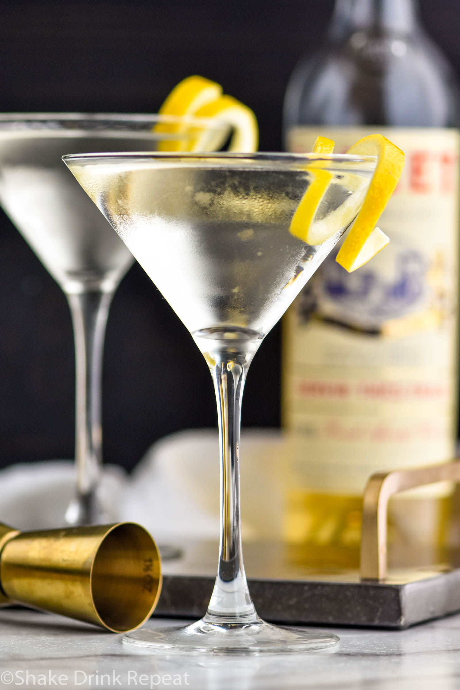 two martini glasses of Vesper Martini with lemon twist garnish
