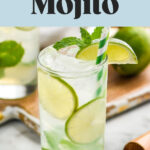 glass of vodka Mojito with ice, straw, slices of lime and mint leaves