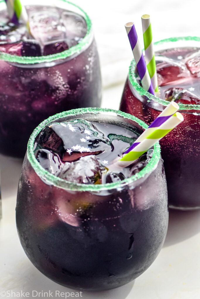 three glasses of Drunk Witch cocktail with ice and straws