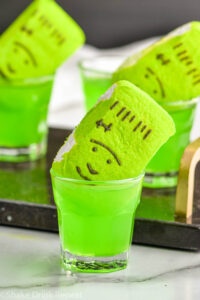 shot glasses of Frankenstein Shot recipe with green peep garnish