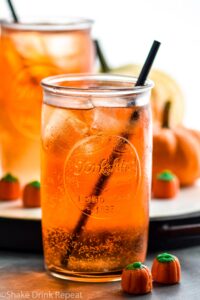 two glasses of Drunk Pumpkin with ice, straw, and pumpkin candies