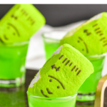 4 shot glasses of Frankenstein Shot recipe with green peep garnish