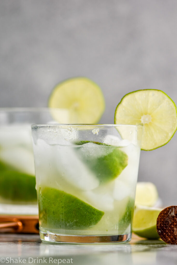 two glasses of Caipirinha with ice and fresh limes