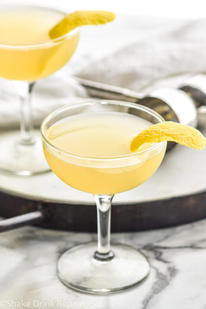 two coupe glasses of Between the Sheets recipe with lemon peel garnish