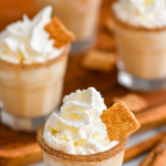 shot glasses of Cinnamon Toast Crunch Shot recipe with cinnamon sugar rim and whipped cream topping