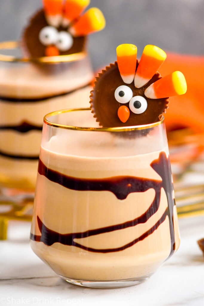 two glasses of Drunk Turkey recipe with chocolate syrup drizzle and peanut butter cup turkey garnish