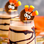 two glasses of Drunk Turkey recipe with chocolate syrup drizzle garnished with turkey peanut butter cup candy