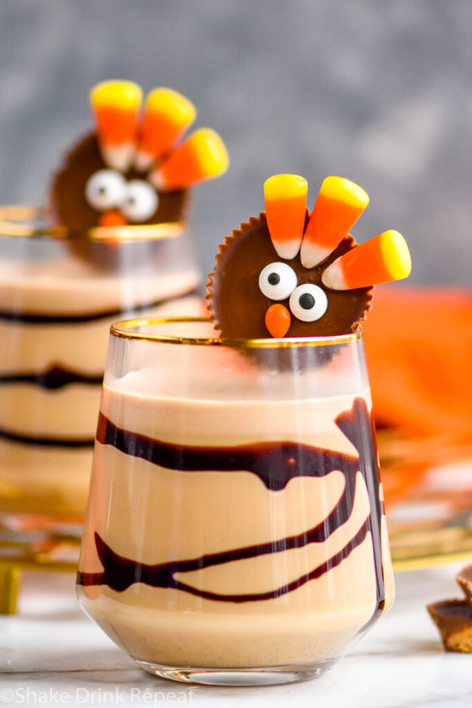 two glasses of Drunk Turkey recipe with chocolate syrup drizzle garnished with turkey peanut butter cup candy