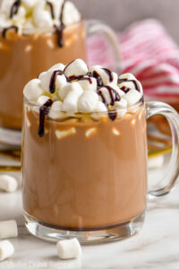 mug of Spiked Hot Chocolate recipe top with marshmallows and chocolate drizzle