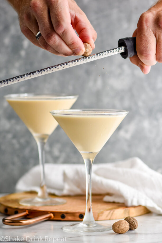 man's hands grating fresh nutmeg over a martini glass of Brandy Alexander Ice Cream recipe